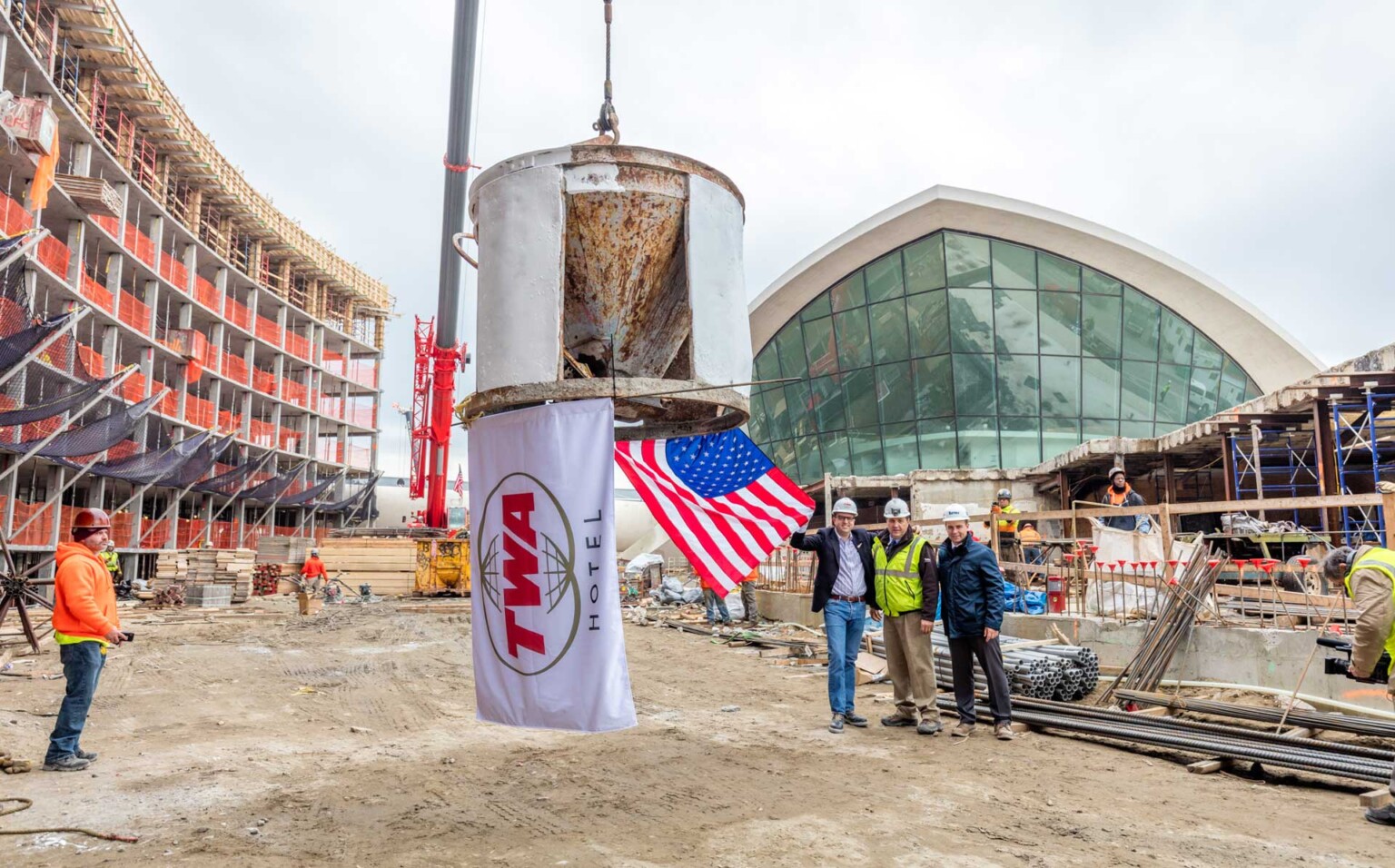 Less Than a Year After Groundbreaking, MCR & Morse Development Top Out the TWA Hotel 1 TWA Topping Out MCR CEO Tyler Morse and Turner Construction’s Rick Faustini and Gary McAssey standing next to the north hotel tower crane with ceremonial flags Max Touhey Metropolitan Airport News