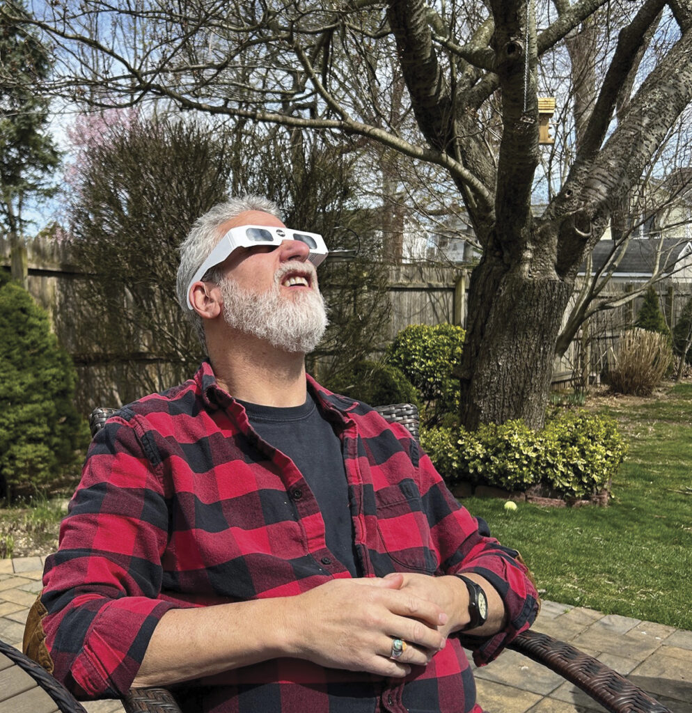 Doug Blum taking in the solar eclipse from the ground in our Long Island, NY backyard.