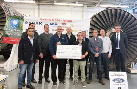 Aviation High School & CALMM Holiday Luncheon and ACGC Check Presentation Airport Community Golf Classic committee members, along with sponsors ASAK Solutions and Ford of Queens, pose with one of two $12,000 checks donated to the Aviation High School Education Foundation and the Council of Airline Maintenance Managers (CALMM).