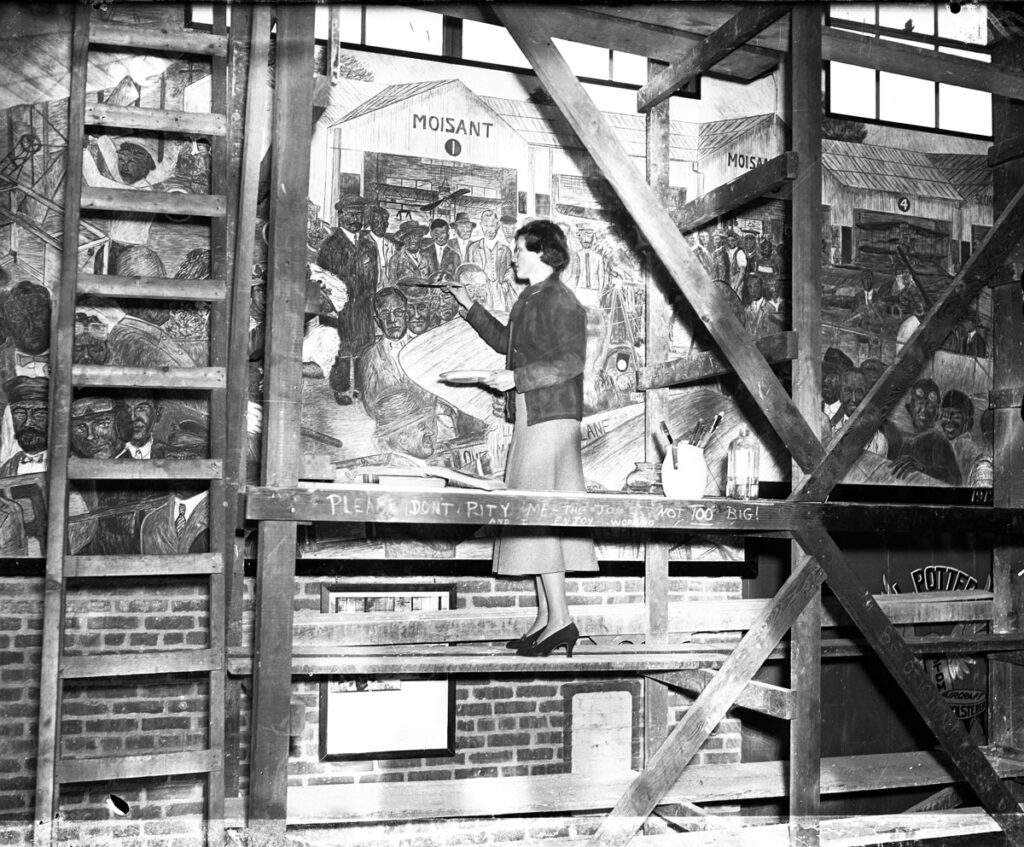 Aline Rhonie painting the Moisant section of her mural Hangar F Roosevelt Field 11 6 1938 Metropolitan Airport News