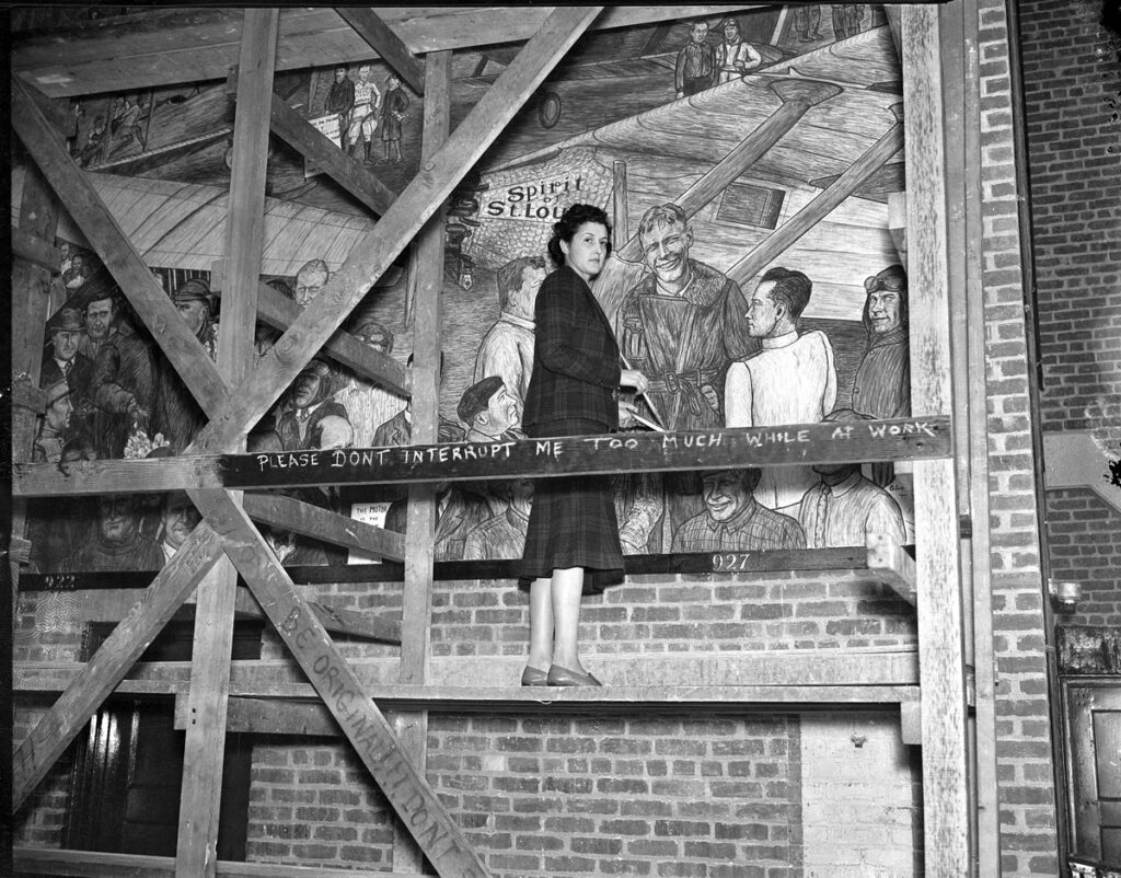 Aline Rhonie painting the mural interior Hangar F Roosevelt Field c.1937 jpg Metropolitan Airport News