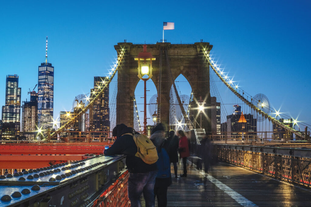 The Brooklyn Bridge offers stunning views of the Manhattan skyline, with iconic landmarks like One World Trade Center and the Empire State Building prominently featured. (Julienne Schaer)