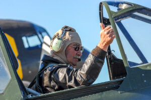 Dan Dameo prepares for flight ops in the cockpit of an American Airpower warbird.