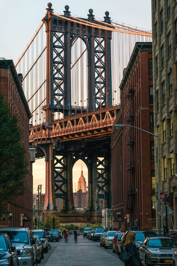 Located along the East River waterfront on Washington Street, in between Plymouth Street and Water Street, is the iconic view of the Manhattan Bridge in DUMBO, Brooklyn. DUMBO stands for “Down Under the Manhattan Bridge Overpass”. (Julienne Schaer)