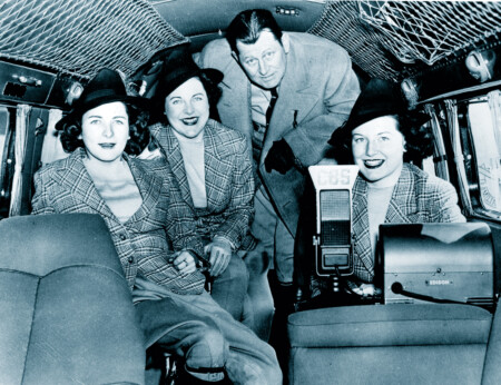 The Flying Hutchinsons Hutchinson Family,Inside Lockheed Electra ‘Amicitia’ prior to 49,545 mi. good will flight to 68 nations, Janet (L) Kathryn at radio, Mrs. Blanche Hutchinson & George Hutchinson, Roosevelt Field,L.I.