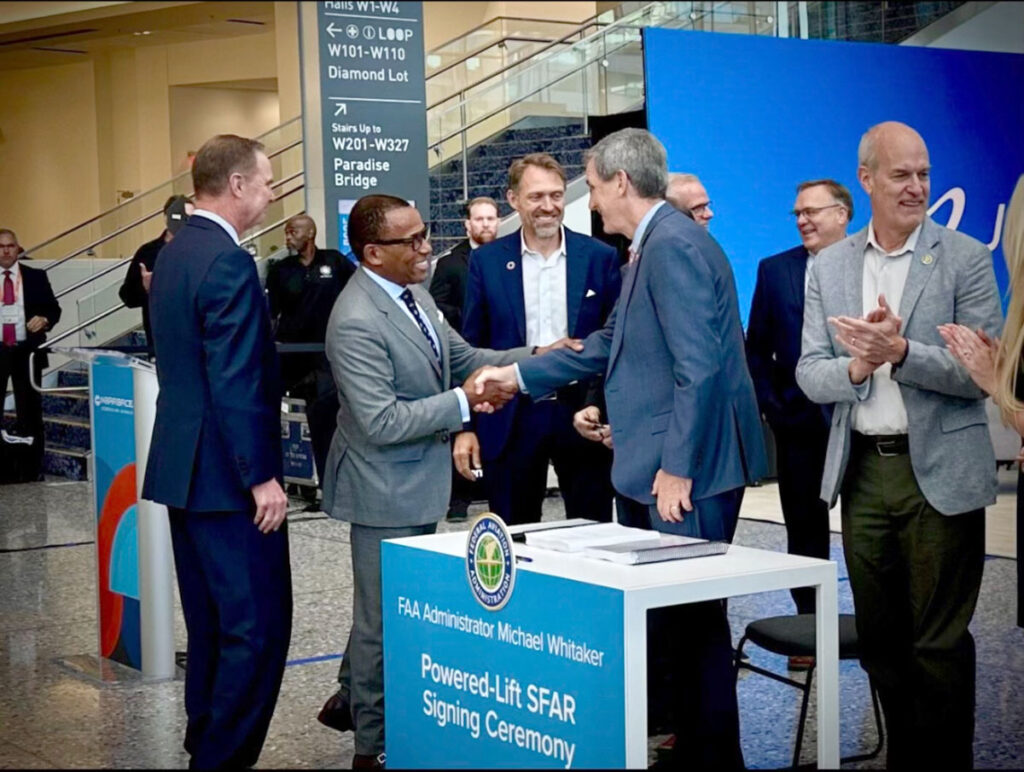 Former FAA Administrator and current Archer Chief Regulatory Affairs Officer, Billy Nolen, shakes hands with current FAA Administrator, Mike Whitaker, shortly after the final powered-lift SFAR is signed.
