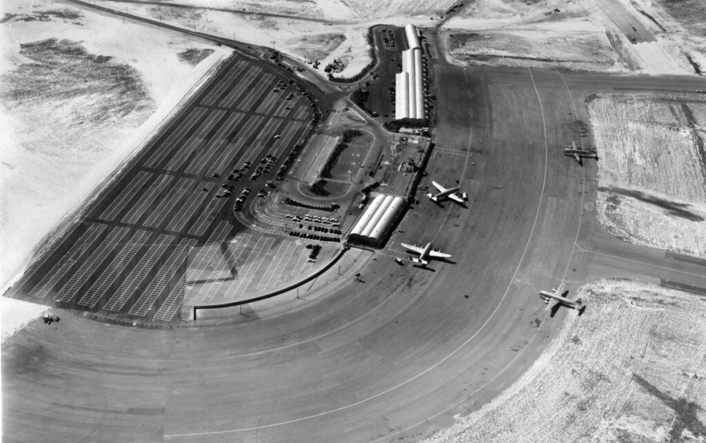 Hope for the Best, Prepared for the Worst New York Airport Aerial view of temporary terminal building and parking lot with four-aircraft-on-ramp. Two Lockheed Constellations and Douglas DC-4's. (1948)