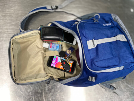 Knapsack with items from pockets inside Metropolitan Airport News