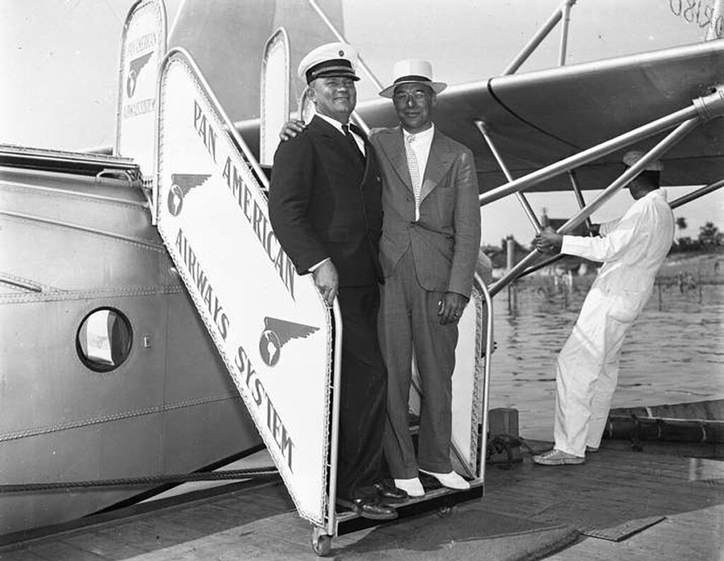 The Port Washington Pan Am Connection Sikorsky S-42 crew member posing with a passenger at the Port Washington Air Service Dock.