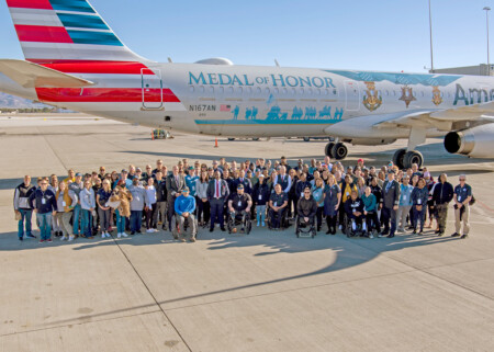 All-Veteran Crew Flies Flagship Valor for Salute to the Troops Event Around 190 participants pose for a photo outside Flagship Valor.